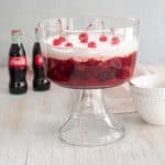 Coca-Cola Salad in a trifle bowl with a bottle of Coke in the background.