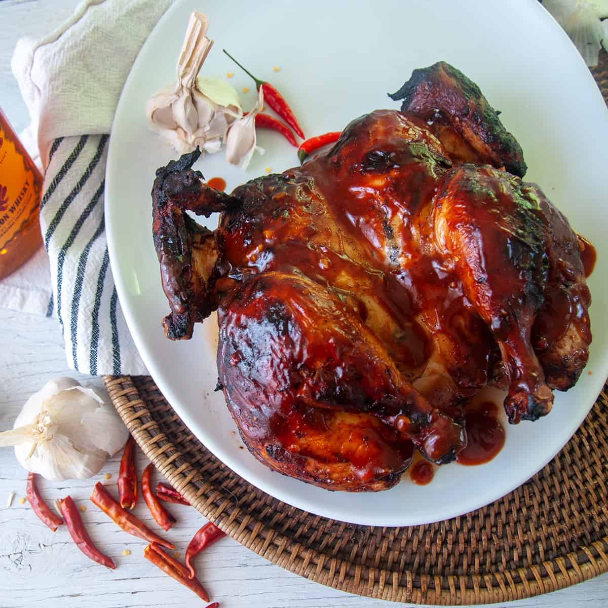 Fireball Whisky BBQ coated Grilled Chicken on a white plate.