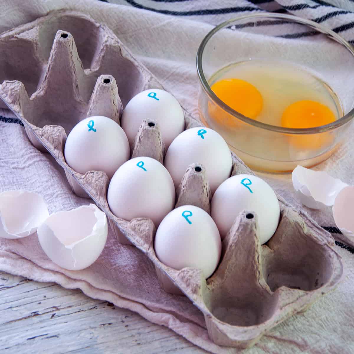 Six pasteurized eggs in an egg carton with the letter 'p' written on them.