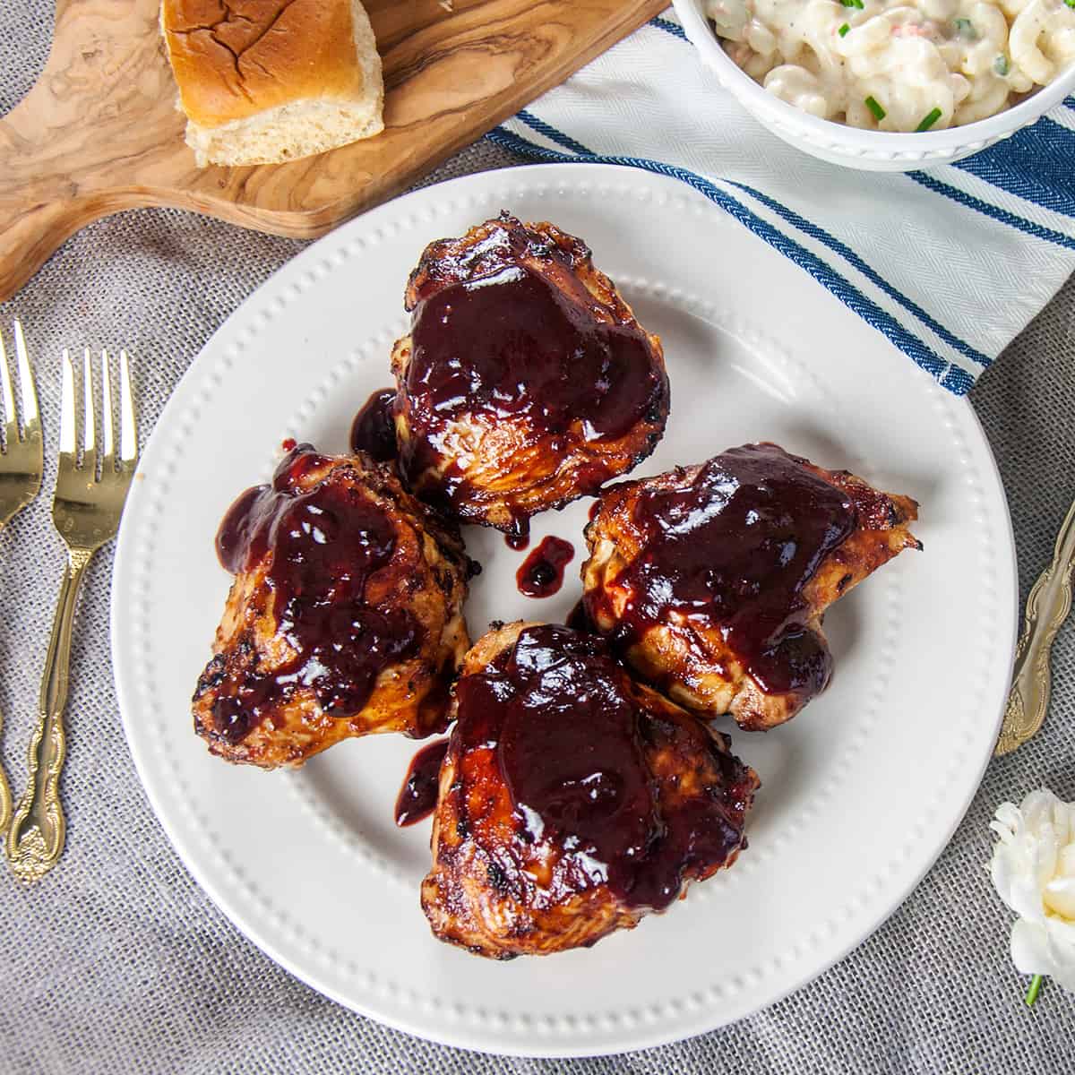 Four grilled chicken thighs with a Homemade BBQ Sauce Recipe.