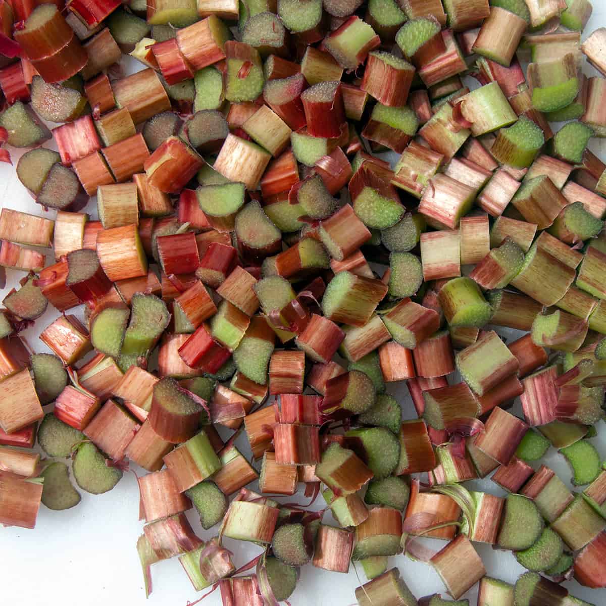 Chopped raw rhubarb on a white plate.