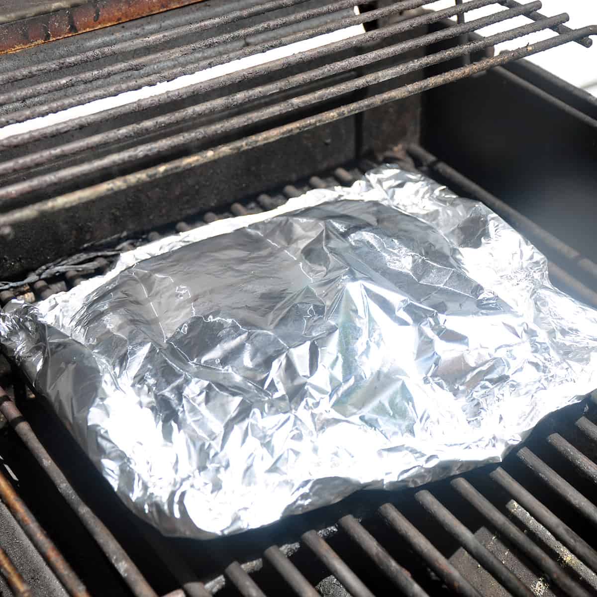 Foil packet on a Weber grill.