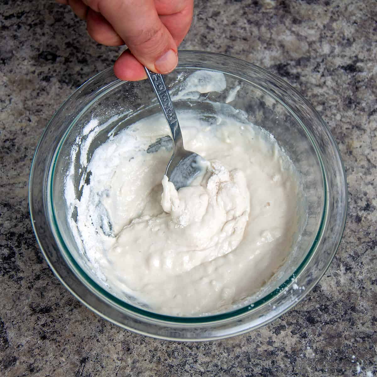 A clear bowl with a flour slurry.