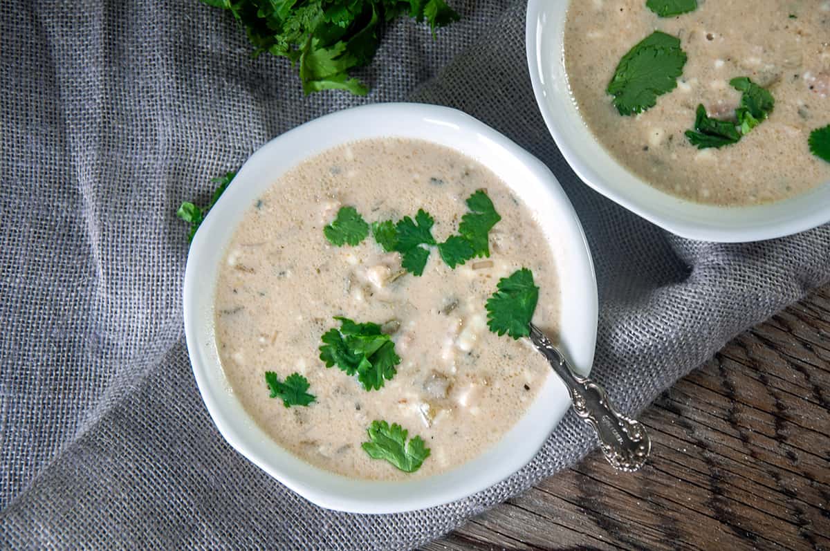 Two bowls of white chicken chili on a cloth.