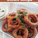 Beer Battered Onion Rings on a white plate.