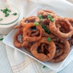 A plate of beer battered onion rings.
