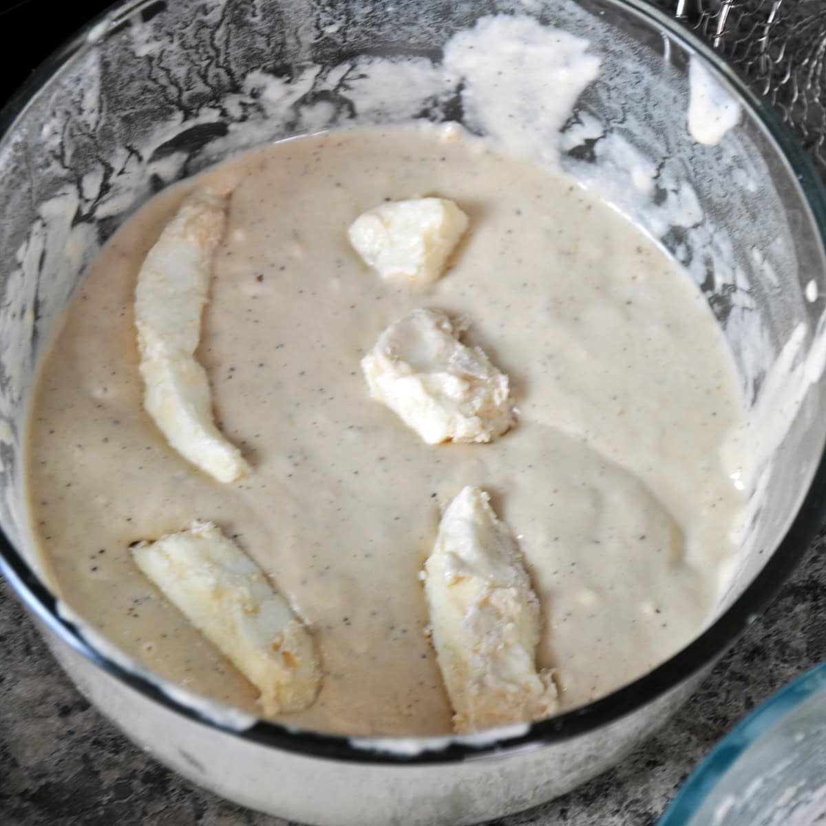 Cheese curds laying in the batter.