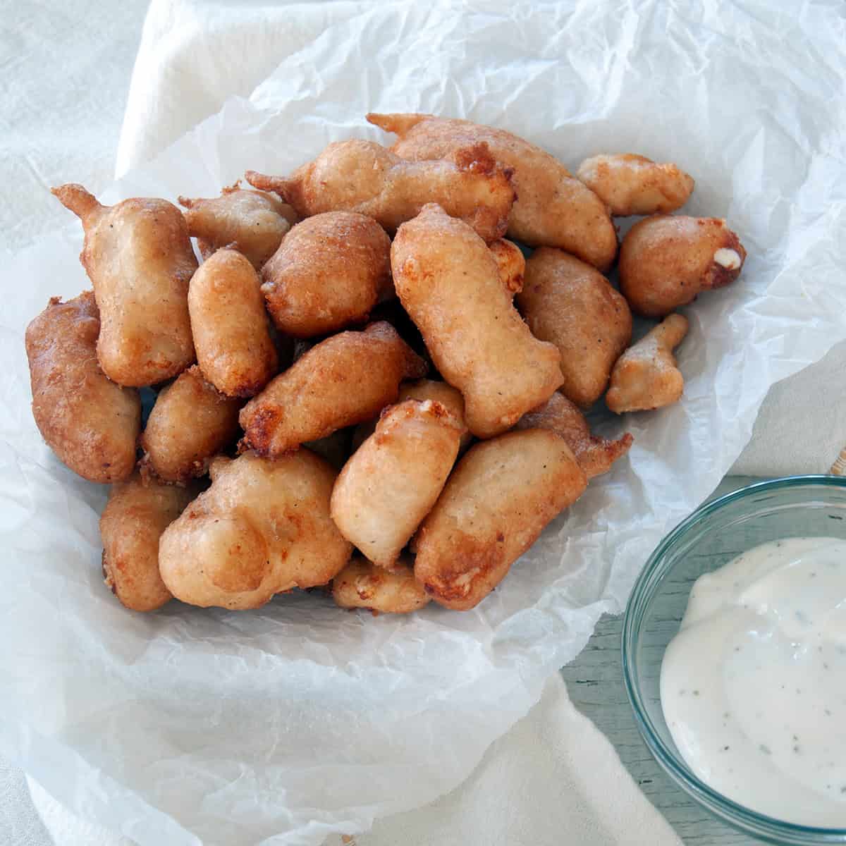 Pile of cheese curds with a side of ranch dressing.