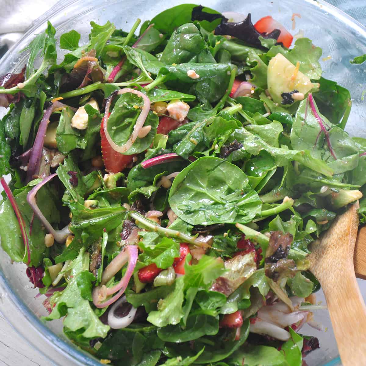 Mixed salad and ingredients in a bowl.