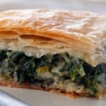 Spanakopita on a white plate.