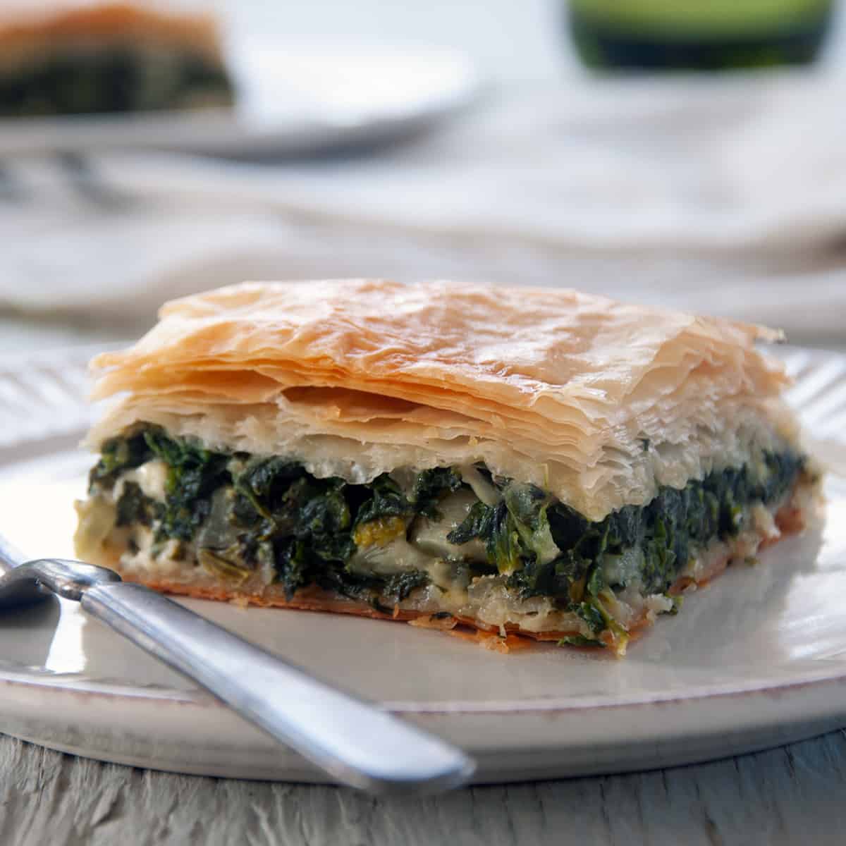 Close up from the side of a piece of spanakopita.
