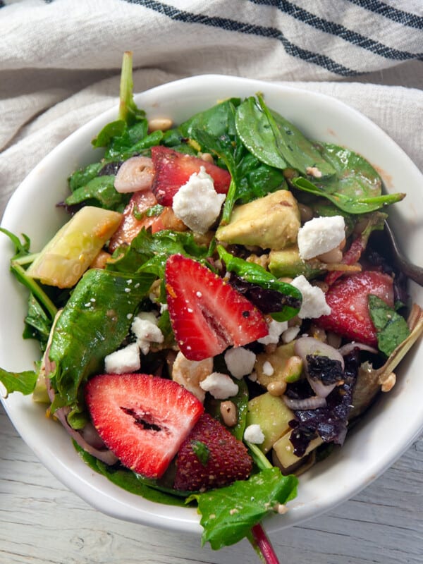 A bowl of strawberry salad with easy vinaigrette salad.