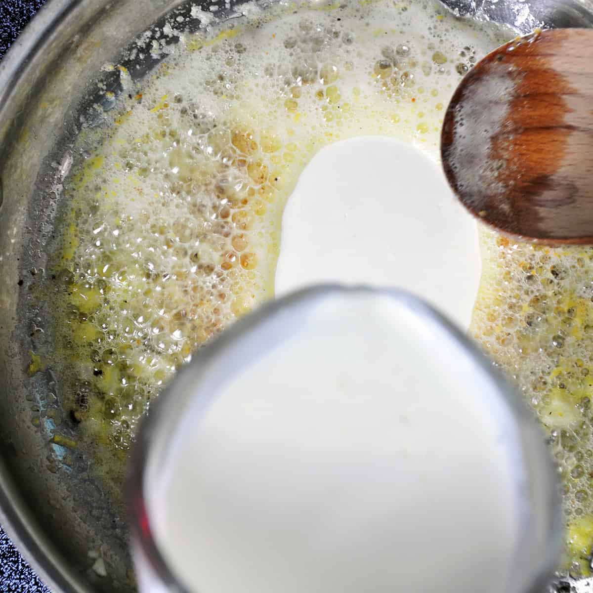 Cream being added to lemon butter sauce.
