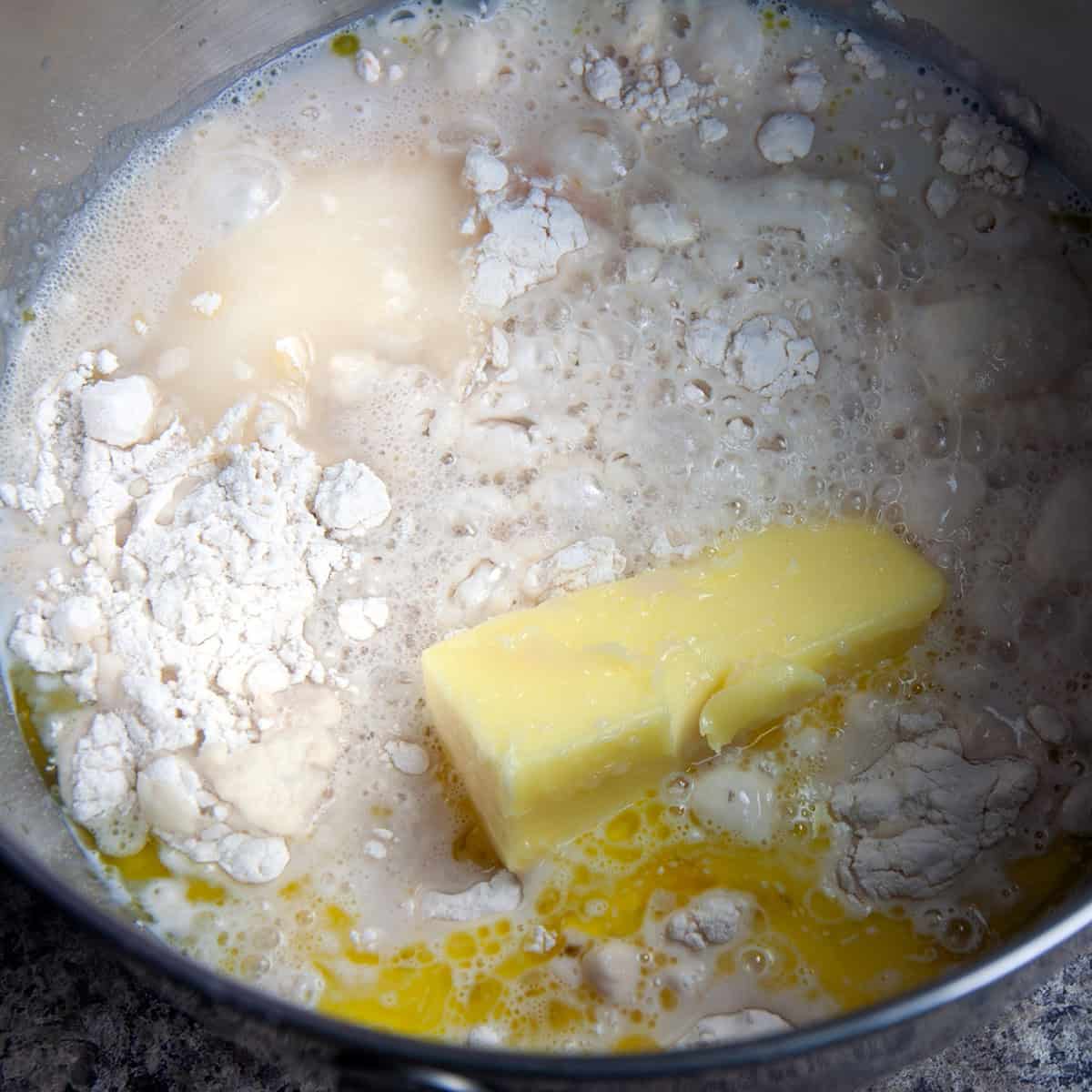 Unmixed dough ingredients in mixing bowl.