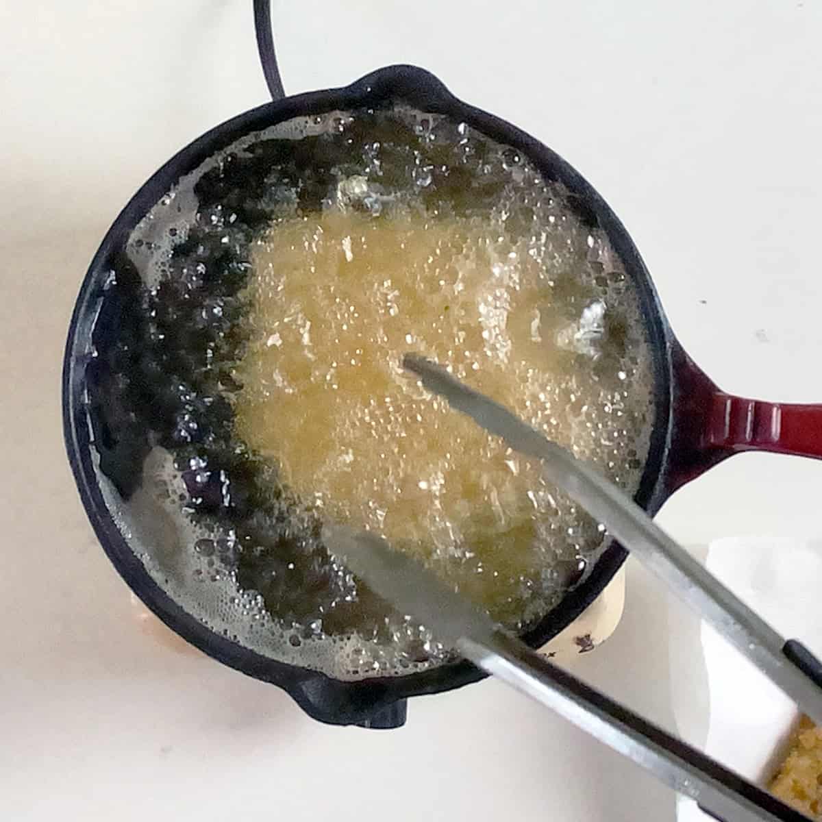 Frying a pork cutlet in a cast iron.