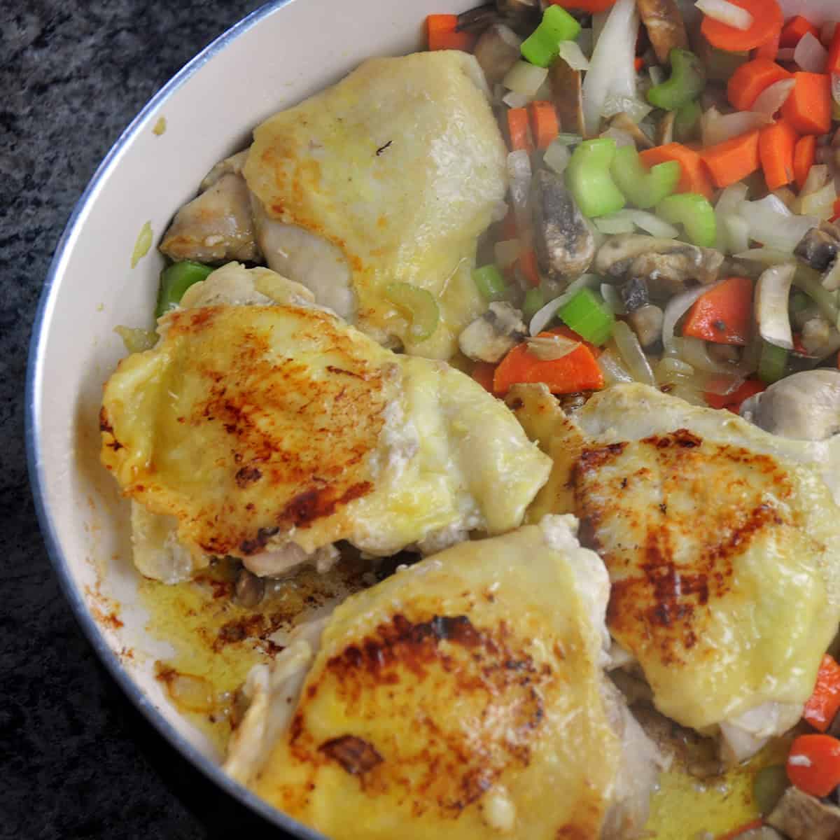 Chicken browning in a sauce pan.