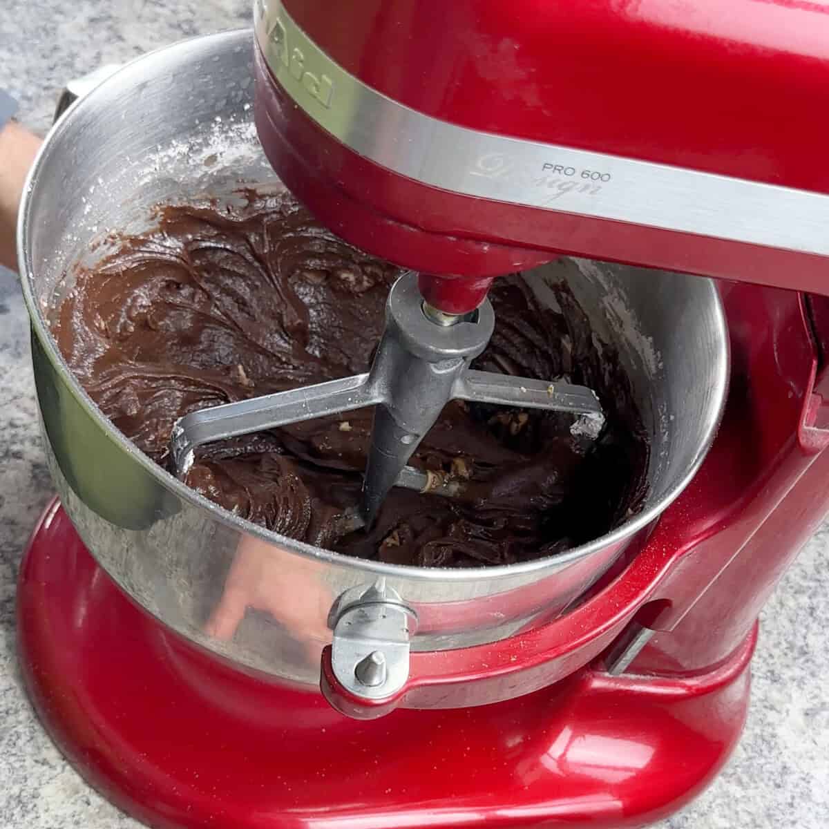 Mix KitchenAid mixer with mixed ingredients that is now Velveeta Fudge.